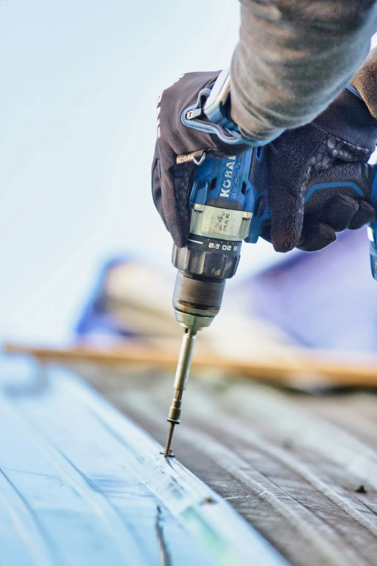 Close-up of roofer repairing shingles