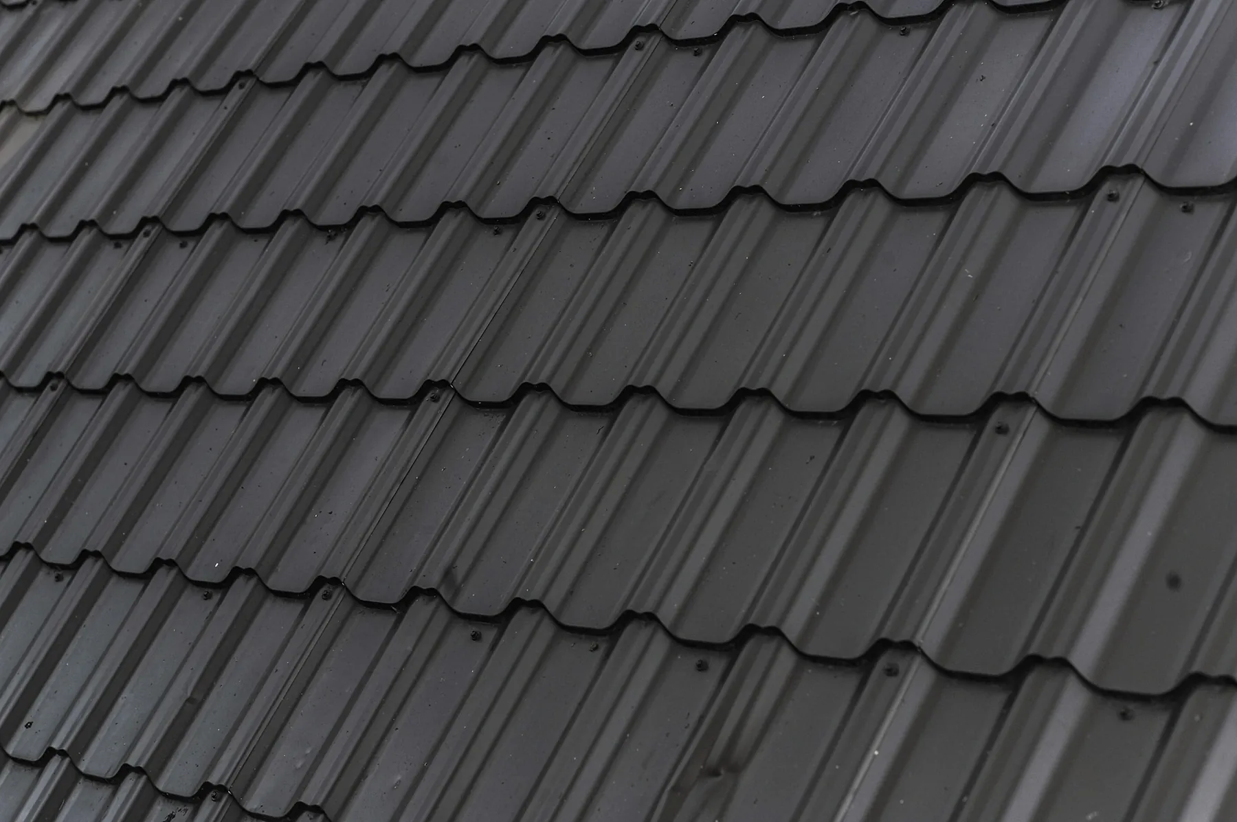Storm repair, dark metal tile detail