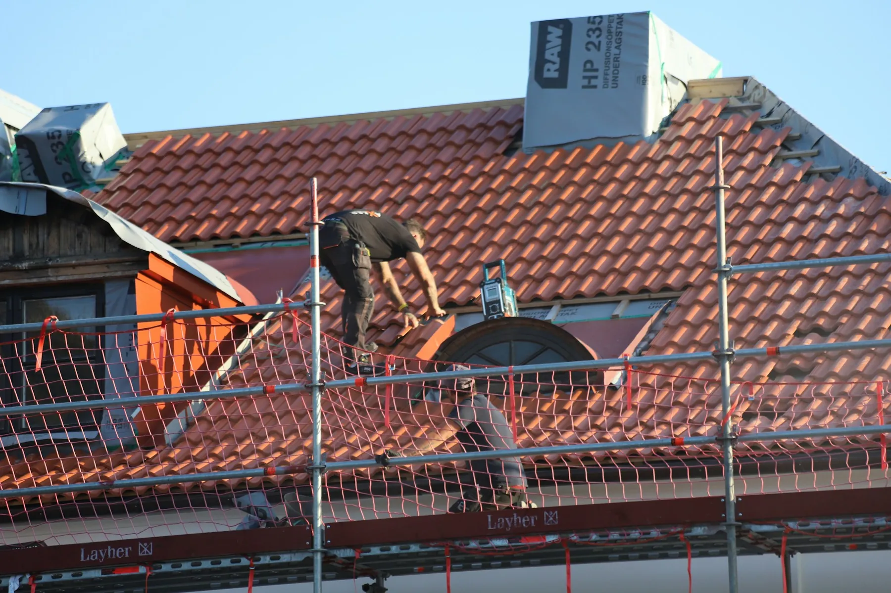 Storm damage roof restoration with scaffolding